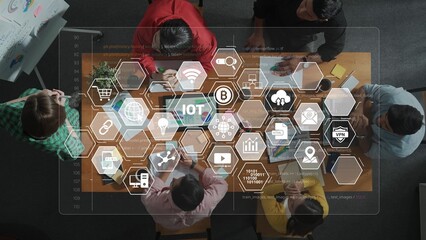 A diverse team engages in collaboration at a modern office table, surrounded by digital icons...