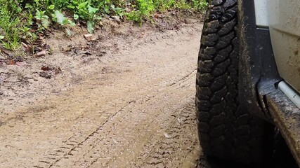 Car splashes through muddy trails on a rugged off-road adventure in high-definition