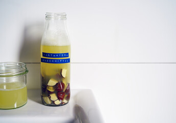 Homemade natural detergent made from chestnuts in a glass bottle.DIY eco-friendly cleaning product using chestnuts as a natural source of saponins. German label visible.Text says "chestnut detergent"