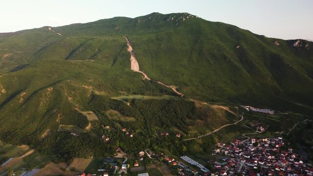Golden Sunlight Bathes Vodno Mountain and the Village of Saraj: A Scenic Aerial Panorama of Skopje, North Macedonia