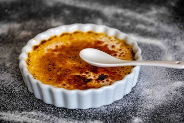 Crème brûlée, creme brulée. Classic creme brulée being flambéed. Burning, flames, cabbage, vanilla bean, blowtorch, sugar, blowtorch.