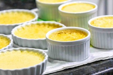 Crème brûlée, creme brulée. Classic creme brulée being flambéed. Burning, flames, cabbage, vanilla bean, blowtorch, sugar, blowtorch.