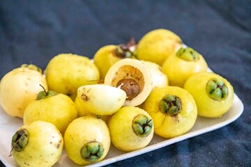 Yellow rose apple or white rose apple, Syzygium jambos. Native to Southeast Asia, this species belongs to the Myrtaceae family, a wild fruit with a rose petal flavor and aroma.
