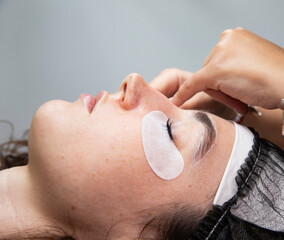 Close-up of a woman's face with eye patches. Beauty salon cosmetology procedures