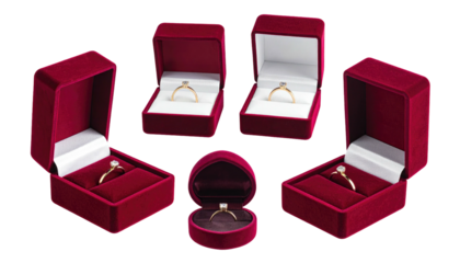 Five red velvet ring boxes, some open, displaying rings with clear stones, set against a black background