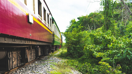 kanchanaburi train railroad tracks green jungle forest thailand