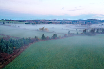 Aerial view of colorful autumn forest with morning mist of Prince Edward Island Canada. High...