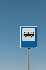 Blue bus stop sign on clear sky