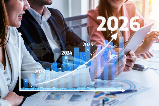 A business team engages in a strategic meeting, analyzing growth projections from 2023 to 2026, with charts displayed on digital devices in a modern office environment. Tessel