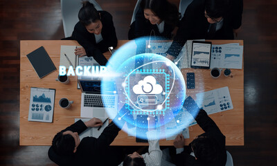 A vibrant modern office scene showcasing a diverse business team discussing data backup solutions with digital visuals. Illustrates collaboration and innovation in technology. Trope