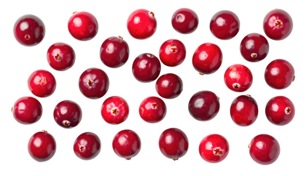 Array of cranberries spread on a black backdrop. Close-up shows their red, glossy, circular shapes