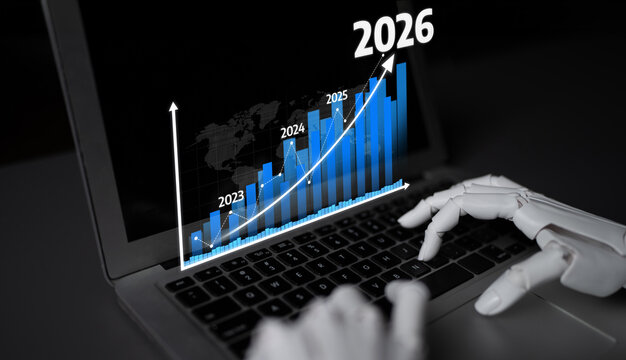 A futuristic representation of business growth showing a robot hand typing data on a laptop with an upward trending graph highlighting predictions for 2026. Tessel