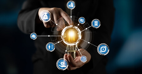 A business professional presents a light bulb symbolizing innovation, with various icons around it depicting technology and creative ideas, representing future possibilities. Crux