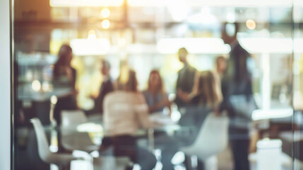 Blurred image of meeting in modern office with group of business people sitting around table, concept for corporate background.