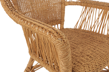 Close up of a woven rattan armchair against a dark background