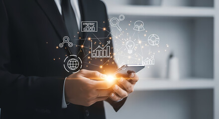 A businessman in a suit holds a smartphone, interacting with digital icons representing business growth and technological advancement.