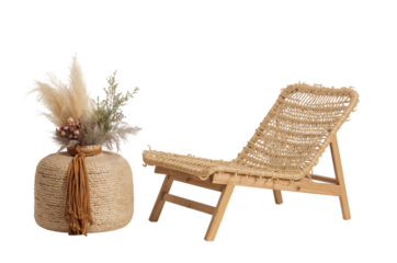 Bohemian style woven chair and dried floral arrangement on black background