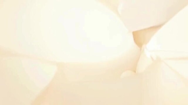 Close-up of crumpled white paper with soft folds and creases.