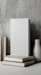 Minimalist Display of Blank Books and Elegant Vase on Concrete Surface