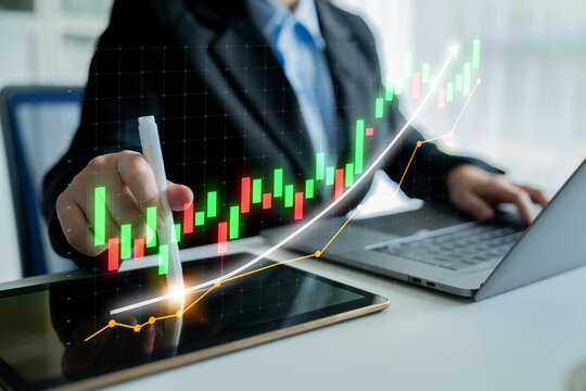 A businessman engaged in financial analysis using a tablet and laptop, surrounded by vibrant stock market charts, emphasizing growth and professional strategy. Impute