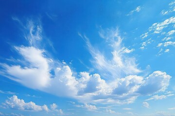Fototapeta premium Bright blue sky with scattered white fluffy clouds under daylight