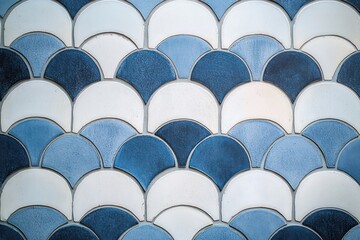 Fototapeta premium Pattern of blue and white ceramic tiles forming a scalloped design with alternating shades creating a textured and calm visual effect