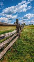 Rustic Wooden Fence along Green Meadow under Blue Sky and Clouds