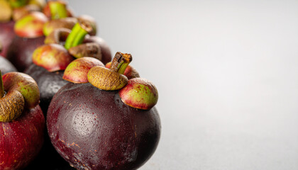 Some Mangosteens close up on a black background. Free space for text