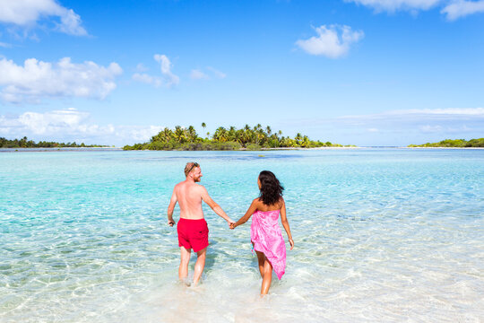 Happy couple of tourists in the lagoon of Tikehau, French Polynesia