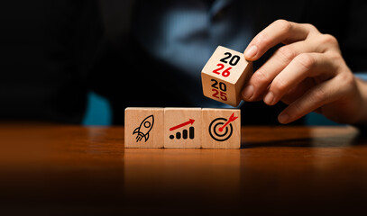 Business planning and growth strategy concept with wooden blocks showing rocket launch, financial chart, target, year 2025 to 2026, symbolizing success, future goals, investment, corporate development