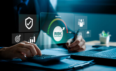 Risk management and financial strategy concept with businessman analyzing investment data and protecting assets, using calculator, digital dashboard to evaluate low, medium, high business risk levels