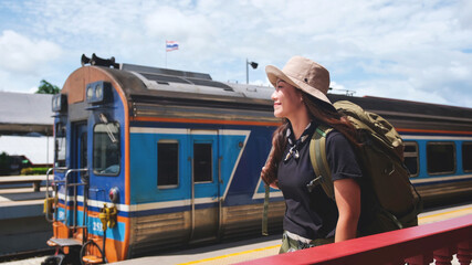 A female backpacker get ready to traveling with the train
