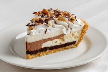 A Slice of Creamy Chocolate and Vanilla Dessert on White Plate Ready for Commercial Presentation in Studio