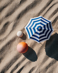 Bright beach essentials including striped umbrella, colorful balls, and soft sand create cheerful summer vibe