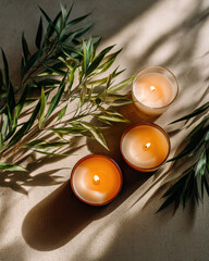 Minimalist flat lay with candles and greenery, creating serene atmosphere with soft shadows and natural elements