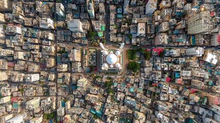 Fototapeta premium Aerial view captures dense urban development surrounding a central domed religious structure