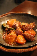 Afghan cuisine: mutton karahi with with tomatoes and shishito peppers
