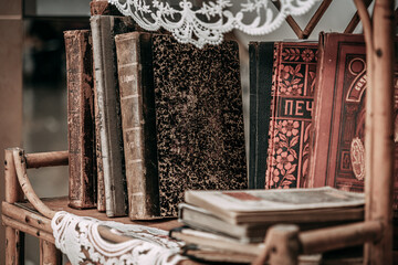 Old paper books are on a vintage bookcase