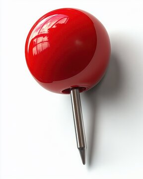 Glossy red push pin with metal needle casting a shadow on a white surface