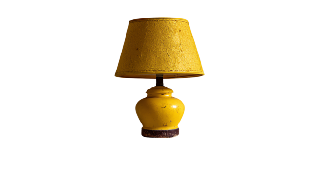 Radiant Illumination: A vintage-style table lamp with a classic yellow lampshade illuminates a space, casting a warm and inviting glow.