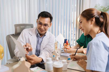 Team of doctors and nurses collaborating in a clinical environment, reviewing treatment options and sharing medical opinions to provide effective patient-centered healthcare solutions.