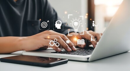 Professional man typing on laptop in creative bright workspace surrounded by digital holographic icons representing learning, education, and innovation.