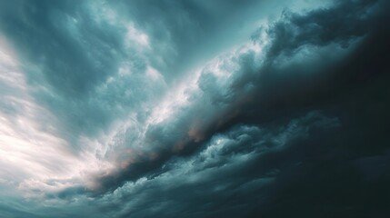 Obraz premium Dramatic turquoise and dark storm clouds fill the expansive sky overhead