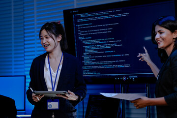 A diverse team with an Asian female, an Indian female and a Caucasian male collaborates in a...