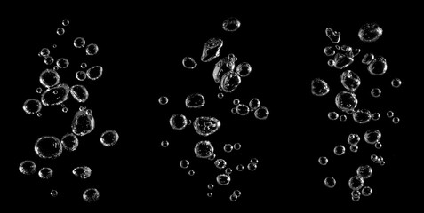 Realistic air bubbles rising in water isolated on black background, perfect for underwater design, beverage advertising, and digital compositing projects. Ideal for creative effects and motion