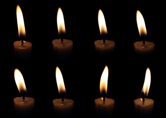 Collection of burning candle flames isolated on black background, showing realistic fire light and wax texture. Perfect for spiritual concepts, memorial design, or warm lighting visual effects.