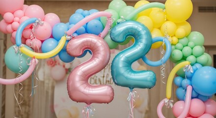 Two large foil '22' balloons anchor a festive pastel arch for a birthday party