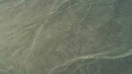 The unique Nazca lines in the desert. There is a monkey drawing and many parallel lines on the sandy plateau. View from the plane. Peru. © Вера 
