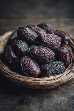 Dates or dattes palm fruit in wooden bowl is snack healthy, Set of various dates in bowl, Different kind of raw date fruit ready to eat, concrete background, Traditional, delicious and healthy ramadan