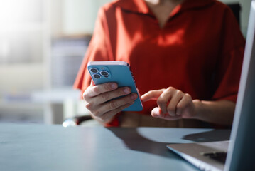 Business professional using smartphone for digital communication, apps, and online connection.